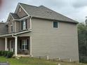 Side view of a two-story home featuring stone and siding accents at 1461 Judson Way, Riverdale, GA 30296