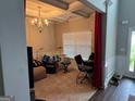 Inviting living room featuring a coffered ceiling and a chandelier at 1461 Judson Way, Riverdale, GA 30296