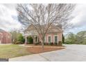 Brick home with manicured landscaping and sidewalks at 217 Brunswick Dr, Tyrone, GA 30290