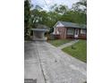 Exterior view of a brick house with a paved driveway leading to a carport at 1079 Pine Ne St, Conyers, GA 30012