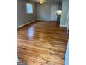 Open living room boasting gleaming hardwood floors, a ceiling light, and a fresh coat of neutral paint at 1079 Pine Ne St, Conyers, GA 30012