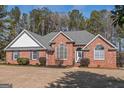 Attractive brick home with ample windows, mature landscaping, and a neatly kept front yard at 5003 Samantha Ct, Mcdonough, GA 30252