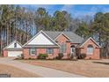 Well-maintained brick home with a clean lawn, attached garage, and classic architectural design at 5003 Samantha Ct, Mcdonough, GA 30252