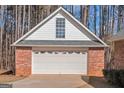 Spacious detached garage featuring a clean white door and a complementary brick and siding exterior at 5003 Samantha Ct, Mcdonough, GA 30252