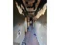 Hallway view showing peeling paint and debris, suggesting significant damage and extensive renovation needs at 950 Joseph E Boone Nw Blvd, Atlanta, GA 30314