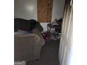A messy living room features minimal furnishings, damaged walls and discarded items indicating poor condition and needed repairs at 950 Joseph E Boone Nw Blvd, Atlanta, GA 30314