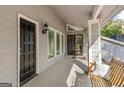 Inviting front porch features a hanging swing and a glimpse of the home's stone-accented entryway at 205 Raintree Bnd, Peachtree City, GA 30269