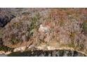 Charming aerial view showcases the house near a tranquil river, surrounded by beautiful trees and natural scenery at 3212 Sw Woodhaven Sw Ct, Conyers, GA 30094