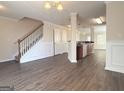 Open-concept living area boasts modern flooring, wainscoting, and seamless kitchen access at 661 Outlook Way, South Fulton, GA 30349