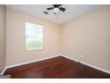 Clean bedroom with hardwood floors and a window with natural light at 4691 Garden Hills Ct, Stone Mountain, GA 30083