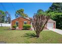 Inviting single-story home with a well-manicured lawn and mature landscaping at 4691 Garden Hills Ct, Stone Mountain, GA 30083