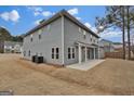Back exterior of home featuring a concrete patio and gray siding at 250 Stonecreek Pkwy, Covington, GA 30016
