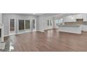 Open-concept living room features hardwood floors, fireplace and sliding glass doors at 250 Stonecreek Pkwy, Covington, GA 30016