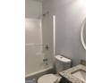 Bathroom featuring a shower-tub combo, toilet, and vanity with granite countertop at 25 Dove Pt, Covington, GA 30016