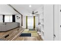 Open dining area and living room with wood flooring and stylish lighting at 6490 Cainwood Dr, Atlanta, GA 30349