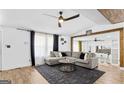 Comfortable living room with modern ceiling fan and dark grey rug at 6490 Cainwood Dr, Atlanta, GA 30349