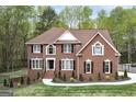 Charming brick home featuring black shutters, manicured landscaping and curved windows at 20 Allie Dr, Mcdonough, GA 30252