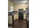 Functional kitchen featuring dark wood floors, granite countertops, and appliances at 579 Wexwood Dr, Riverdale, GA 30274