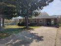 Well maintained tan home with a covered carport area and long concrete driveway at 4365 Newton Cir, Douglasville, GA 30134