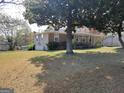 Lovely single story home with mature trees, partial basement access and a covered front porch at 4365 Newton Cir, Douglasville, GA 30134