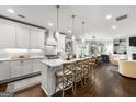 Bright, open kitchen featuring a large island with seating, modern white cabinets, and stainless steel appliances at 2940 Parkridge Ne Dr, Brookhaven, GA 30319