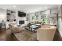 Cozy living room featuring a white brick fireplace, built-in bookshelves, and large windows for natural light at 2940 Parkridge Ne Dr, Brookhaven, GA 30319