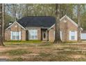 Inviting brick home with a classic design and covered front porch at 12711 Simmons Rd, Hampton, GA 30228