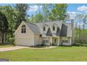 Charming home with a two-car garage, dormer windows, and a well-maintained lawn and landscaping at 2014 Big Cypress Ln, Locust Grove, GA 30248