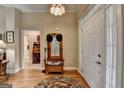 Welcoming foyer with hardwood floors, wooden hall tree, and entry to other rooms at 3230 Riverhill Ct, Cumming, GA 30041