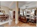 Open concept living room showcasing fireplace, hardwood floors, and comfortable furnishings at 3230 Riverhill Ct, Cumming, GA 30041