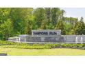 Stone community entrance monument with water features surrounded by lush landscaping at 8593 Secretariat Dr # 20, Lithonia, GA 30058