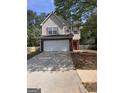 Charming two-story home features a wide driveway and attached two-car garage at 1132 Saint Phillips Ct # 90, Locust Grove, GA 30248