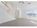 Bright living room featuring a staircase, large window, and neutral carpet at 5728 Rock Shoals Way, Atlanta, GA 30349