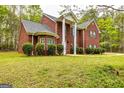 Charming brick house with prominent white columns and a well-kept green lawn in a wooded area at 1015 Middlebrook Dr, Mcdonough, GA 30252