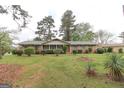 Traditional brick home with a well-manicured lawn and mature trees at 3257 Greenvale Way, Decatur, GA 30034