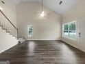 Bright living room with vaulted ceiling and large windows allowing ample natural light at 7747 Roundtree Xing, Riverdale, GA 30274