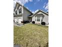 Well-maintained front yard of a two-story home with a neat lawn and charming landscaping at 55 Long Dr, Covington, GA 30016
