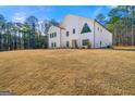 Bright white modern farmhouse exterior with well-maintained lawn, offering curb appeal at 130 Wesley Pl, Fayetteville, GA 30214