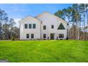 Beautiful modern farmhouse with black trim windows and a spacious green lawn at 130 Wesley Pl, Fayetteville, GA 30214