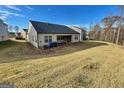 Spacious backyard with a grassy slope, offering ample space for outdoor activities at 4090 Spencer Ln, Stonecrest, GA 30038