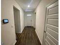 Inviting hallway with hardwood floors leading to the main entrance of the home at 4090 Spencer Ln, Stonecrest, GA 30038