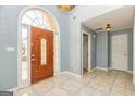 Light-filled foyer with tiled floors, a decorative front door, and neutral paint at 230 Hidden Brook Trl, Fayetteville, GA 30215