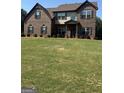 Beautiful brick home with a spacious, green lawn and symmetrical window design at 110 Broadwater Dr, Fayetteville, GA 30214