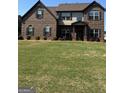 Charming two-story brick home boasts a large lawn and balanced facade at 110 Broadwater Dr, Fayetteville, GA 30214