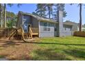 Backyard featuring a raised wooden deck, perfect for outdoor entertaining at 9689 Pintail Trl, Jonesboro, GA 30238
