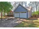 Spacious two-car garage showcasing painted siding, complemented by a double wide driveway at 9689 Pintail Trl, Jonesboro, GA 30238
