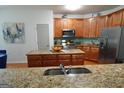 Well-equipped kitchen with stainless steel appliances, granite countertops, and a functional island at 480 Meadow Sage Ln, Fayetteville, GA 30214