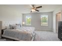 Comfortable main bedroom offering a ceiling fan, plush carpet, and two windows with pleasant views at 8708 Lakeview Commons # 47, Jonesboro, GA 30238