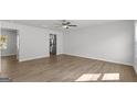 Spacious living room with wood-look flooring and ceiling fan, flowing into the modern kitchen area at 7264 Crestside Dr # 66, Austell, GA 30168
