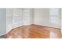 Bright bedroom featuring hardwood floors, neutral paint, large windows, and bay window at 4875 Ben Hill Rd, College Park, GA 30349